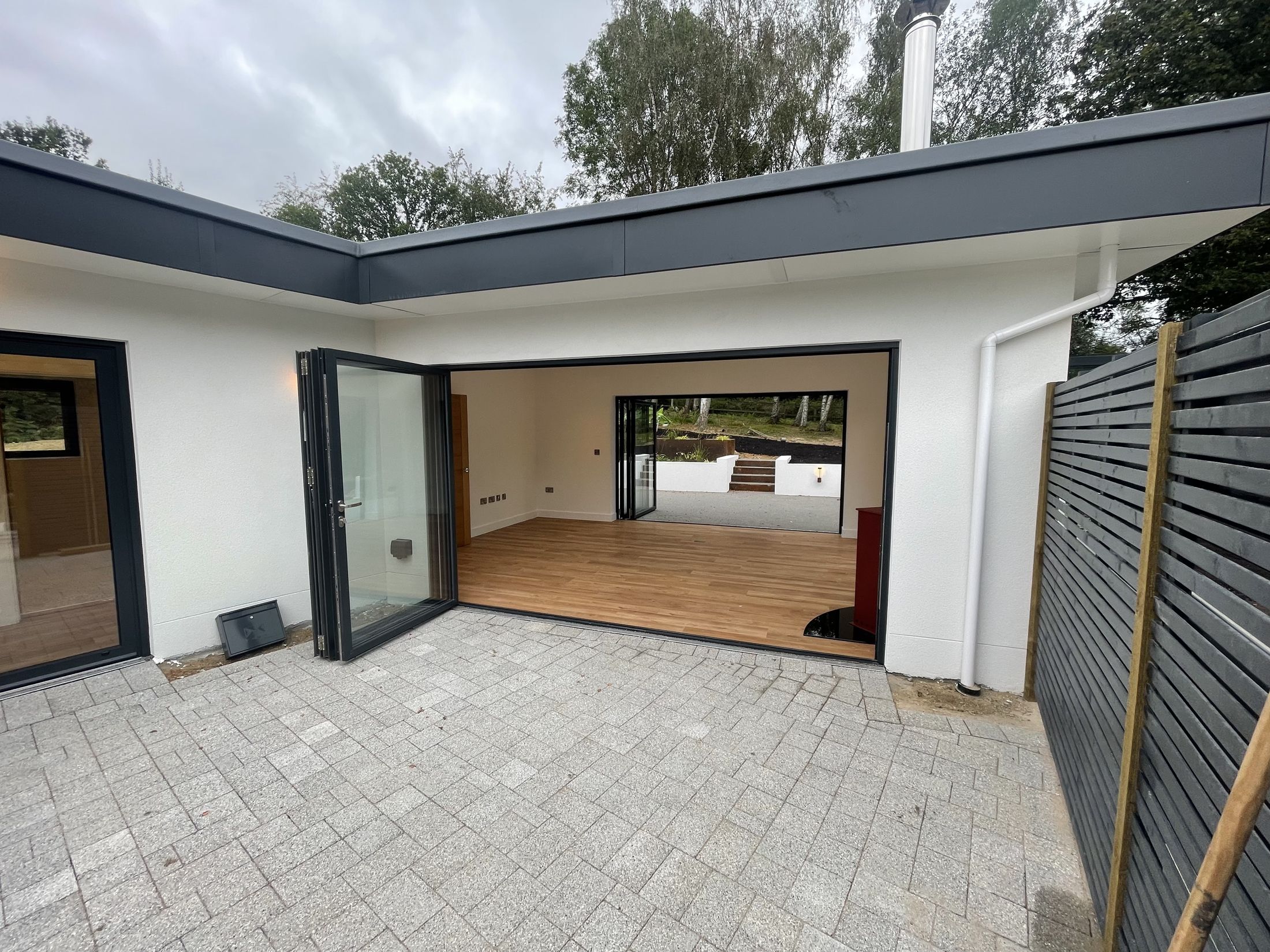 Bolney courtyard with bifold doors open into the house