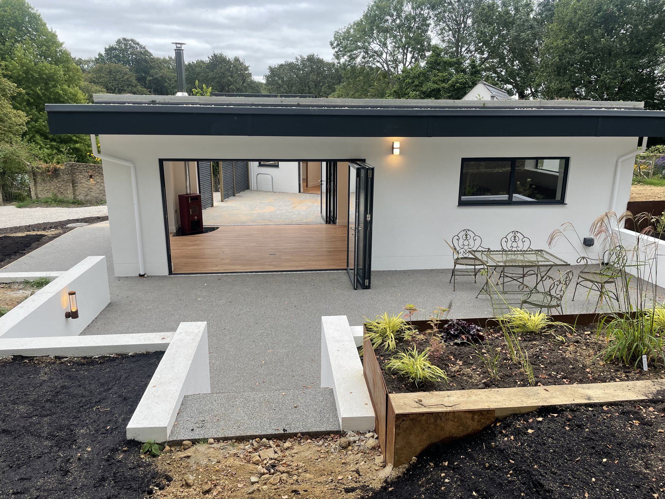 Finished Bolney home from the garden, with terrace and new planting