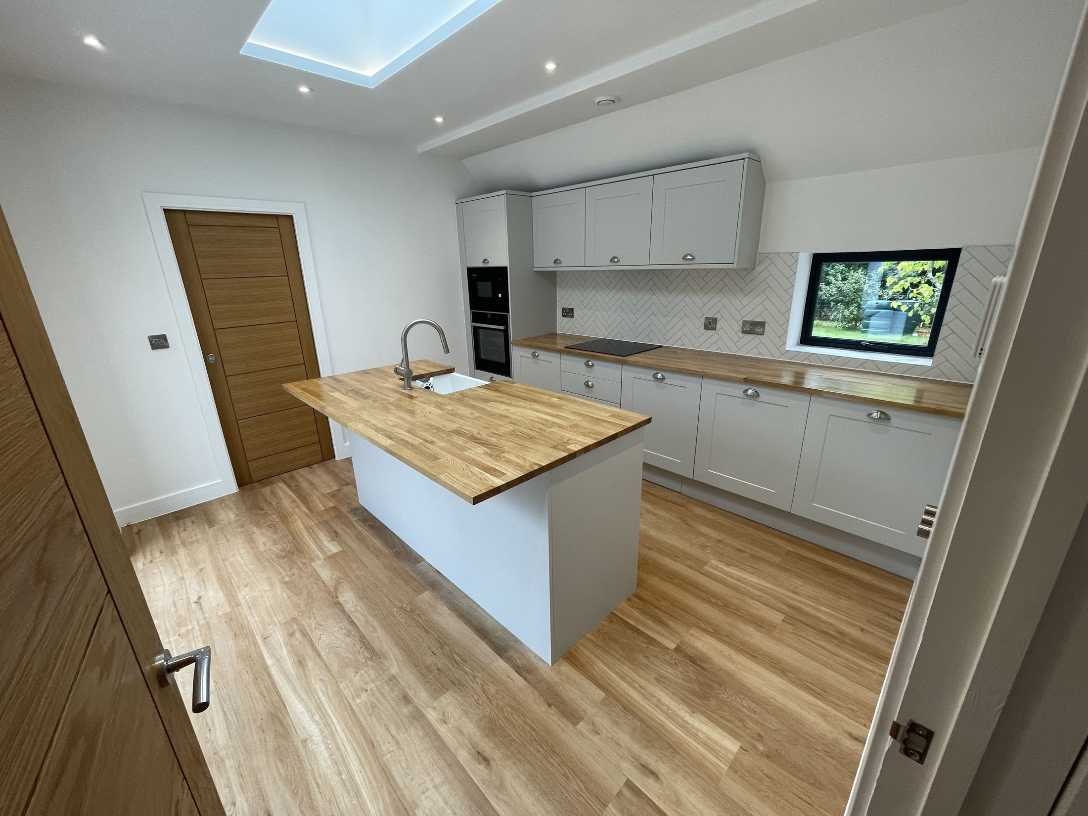 Bolney kitchen with oak worktop island and roof light