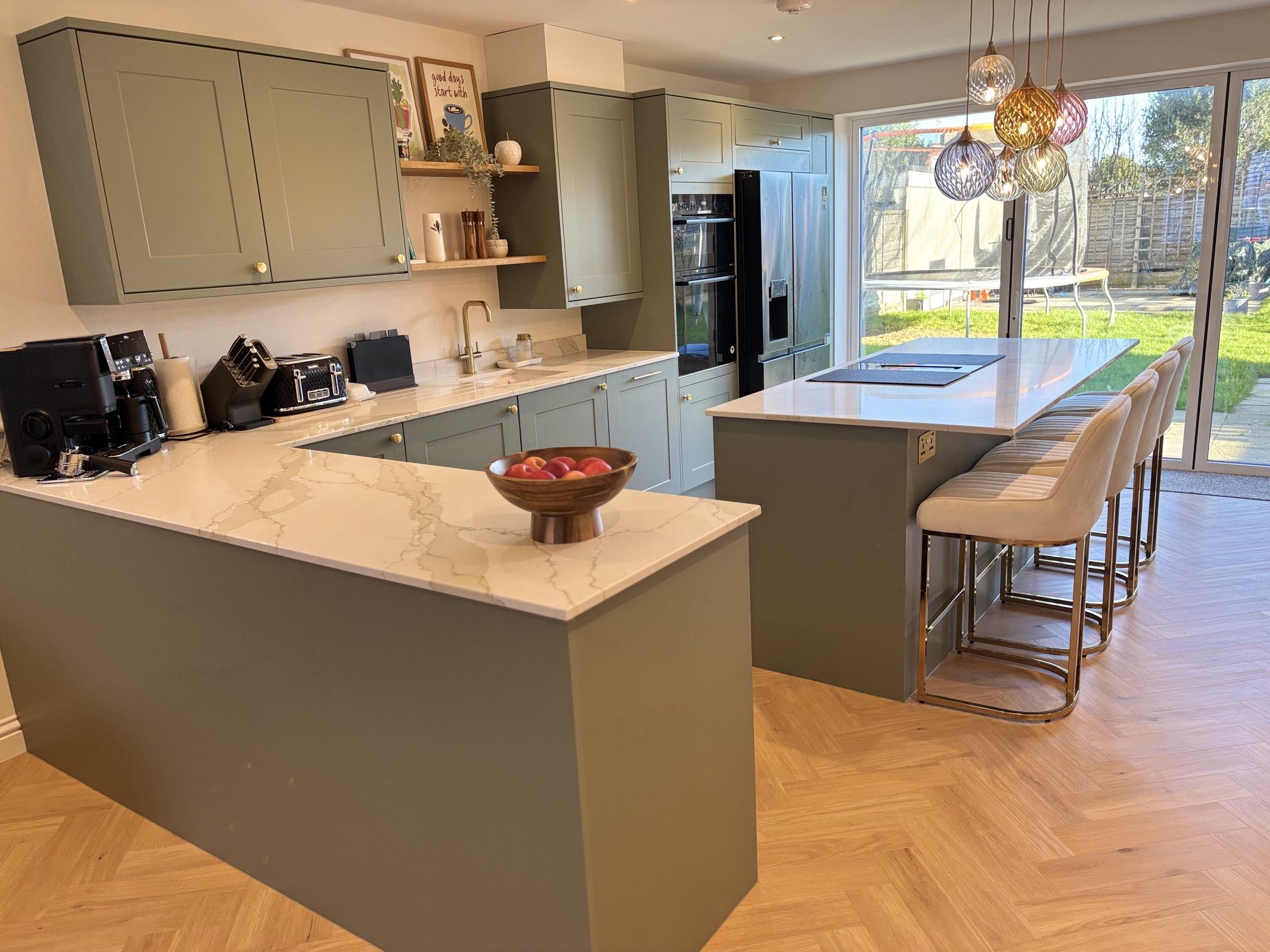 Grinstead Lane kitchen after: sage units, marble-effect island, herringbone floor