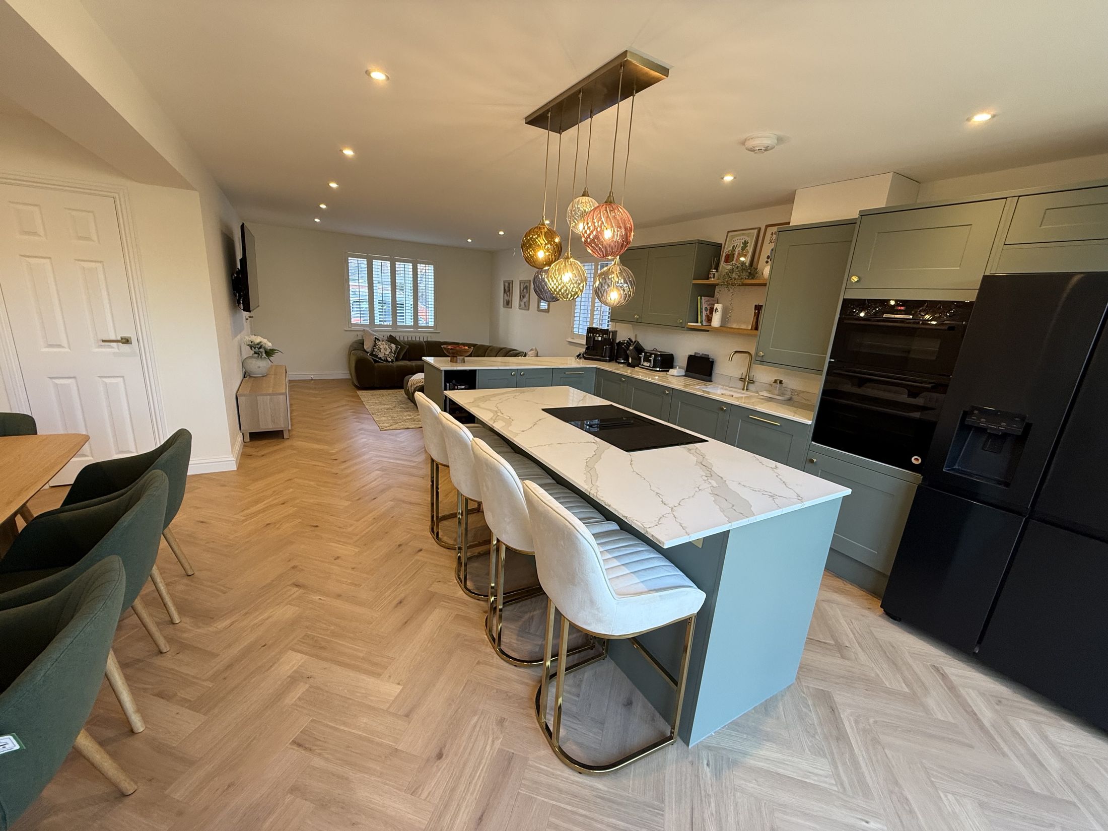 Marble-effect island with bar stools in the Grinstead Lane kitchen