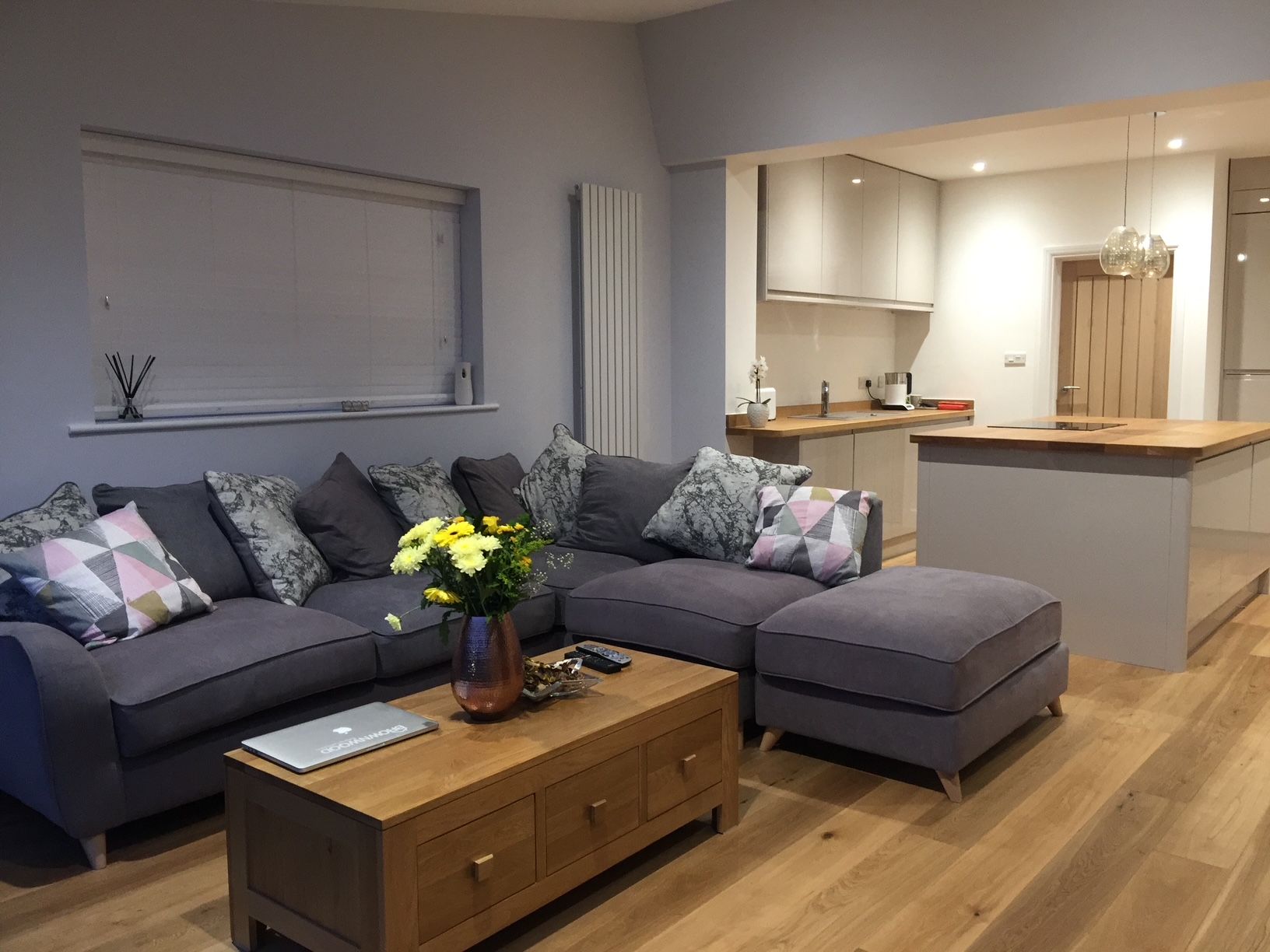 Living area of the St Andrews extension with corner sofa and oak flooring